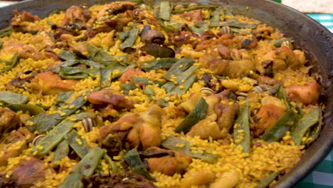 plating of paella on giant pan served on table