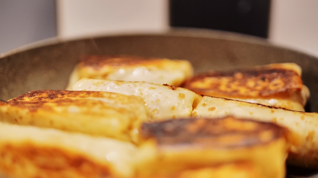 Delicious homemade food scene showing stuffed pancakes cooking on hot skillet