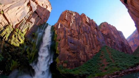 a majestic waterfall cascading down towering canyon walls