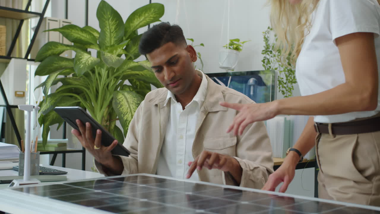 Coworkers Sharing Ideas on Solar Panel Implementation in Business