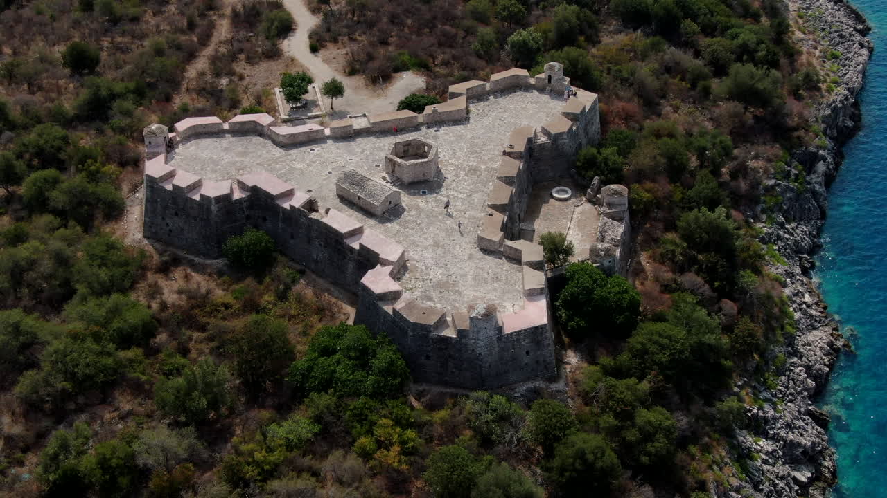 Fantastic circular aerial shot and a short distance over the castle of Porto Palermo in Albania and visualizing the wonderful landscape