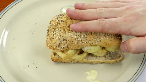 Closing-fried-squid-sandwich-with-cereal-bread