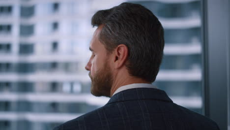 Ceo-man-looking-camera-in-window-office.-Businessman-posing-in-finance-workplace