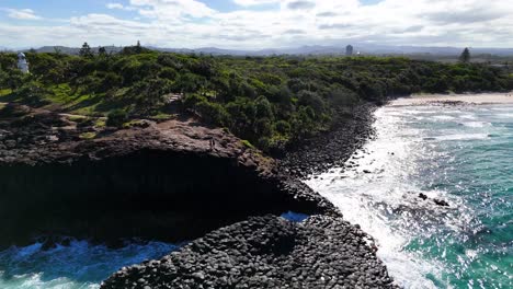 waves crash against unique volcanic rock formations