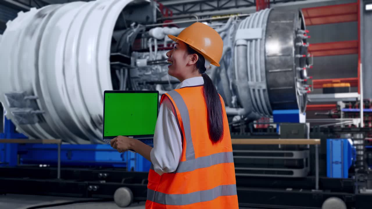 Engineer reviewing equipment on a laptop in a factory