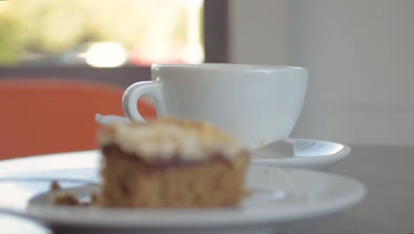 cena en la cafetería mojando galletas en una taza de café.