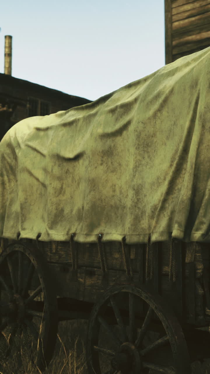 Vintage wagon resting in a rustic western town at sunset