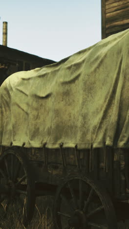 vintage wagon resting in a rustic western town at sunset