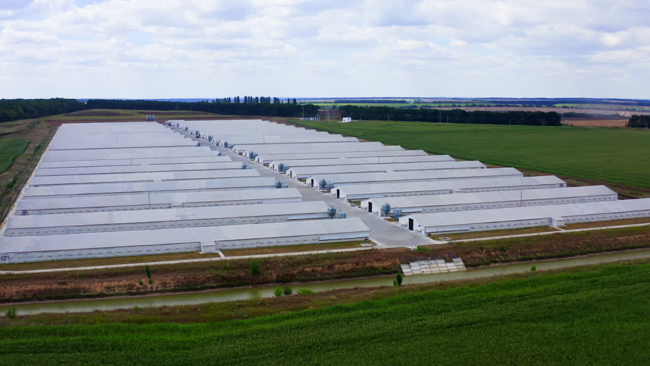 Aerial view of industrial chicken house. Modern farm poultry buildings. Agriculture