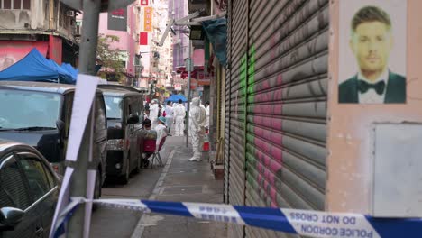 health workers dressed in ppe suits are seen inside a neighborhood area under lockdown to contain the spread of the coronavirus variant outbreak in hong kong