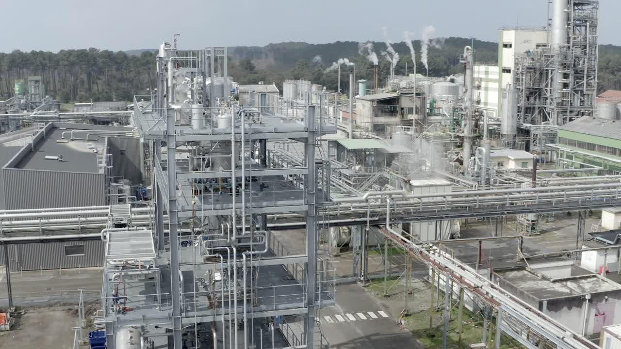 Aerial drone view of complex industrial structures, pipes, and towers at DRT Factory, a key manufacturing facility in Veille-Saint-Girons, France