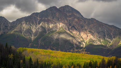 time lapse, idyllic canadian landscape, clouds and shadows moving above valley with aspen forest and mountain peak on fall day, jasper national park