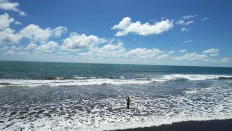 man fishing on the beach alone at low tide