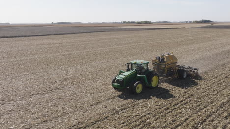 Tractor-Strip-Tilling-Farm-Field-to-Prepare-Soil-for-Planting,-Aerial