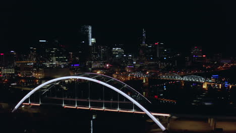 panning up to night time skyline and bridges of downtown nashville tn, 4k