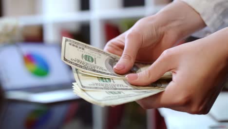 woman hands counting cash money in office. business success concept