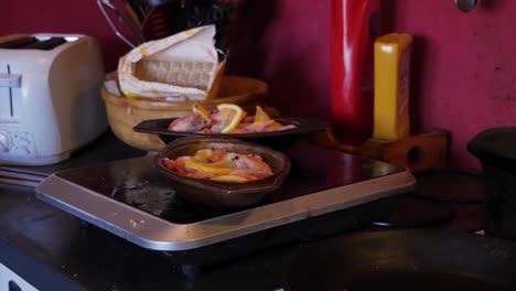 Handheld-Wide-Shot-of-Frozen-Shrimps-With-Lemons-in-a-Silver-Bowl-in-an-Old-Countryside-Kitchen