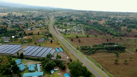 flying low over solar panels on farm in rural africa