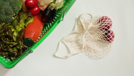 woman shopping for groceries using a reusable shopping bag