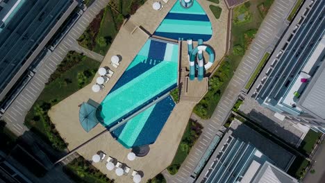 aerial view of modern apartment complex with swimming pool and amenities