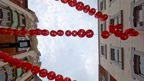 red lanterns strung between buildings in chinatown