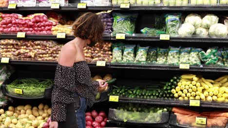 a woman in mask shops in the produce section of a supermarket during the covid19 coronavirus pandemic epidemic 3