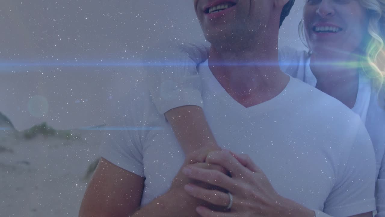 woman climbing onto man's back starting jewelry promo featuring starry overlay highlighting rings