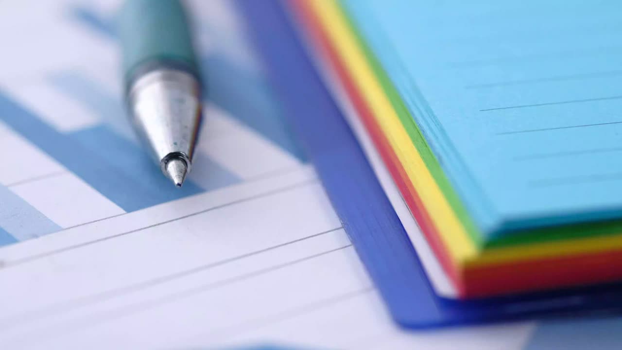Business documents with pen and colorful notes