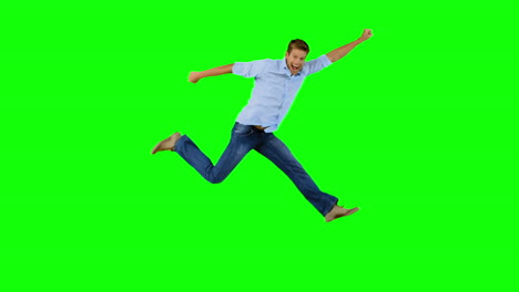 man jumping and gesturing on green screen