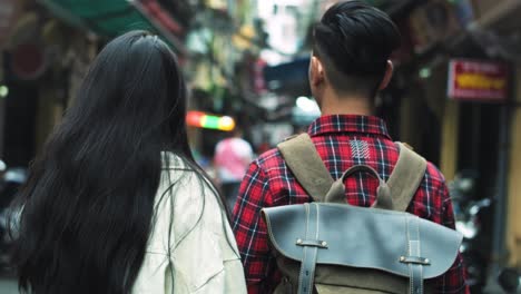 handheld view of couple walking in the vietnamese street