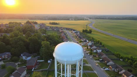 aerial view rising over the watertower in clarksville revealing a beautiful sunrise at the end