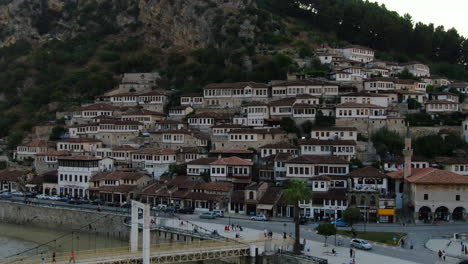 Berat,-city-of-Albania:-aerial-view-in-orbit-to-the-famous-houses-and-Gorica-bridge-during-sunset