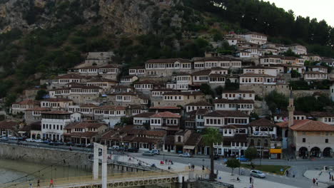 berat, city of albania: aerial view in orbit to the famous houses and gorica bridge during sunset