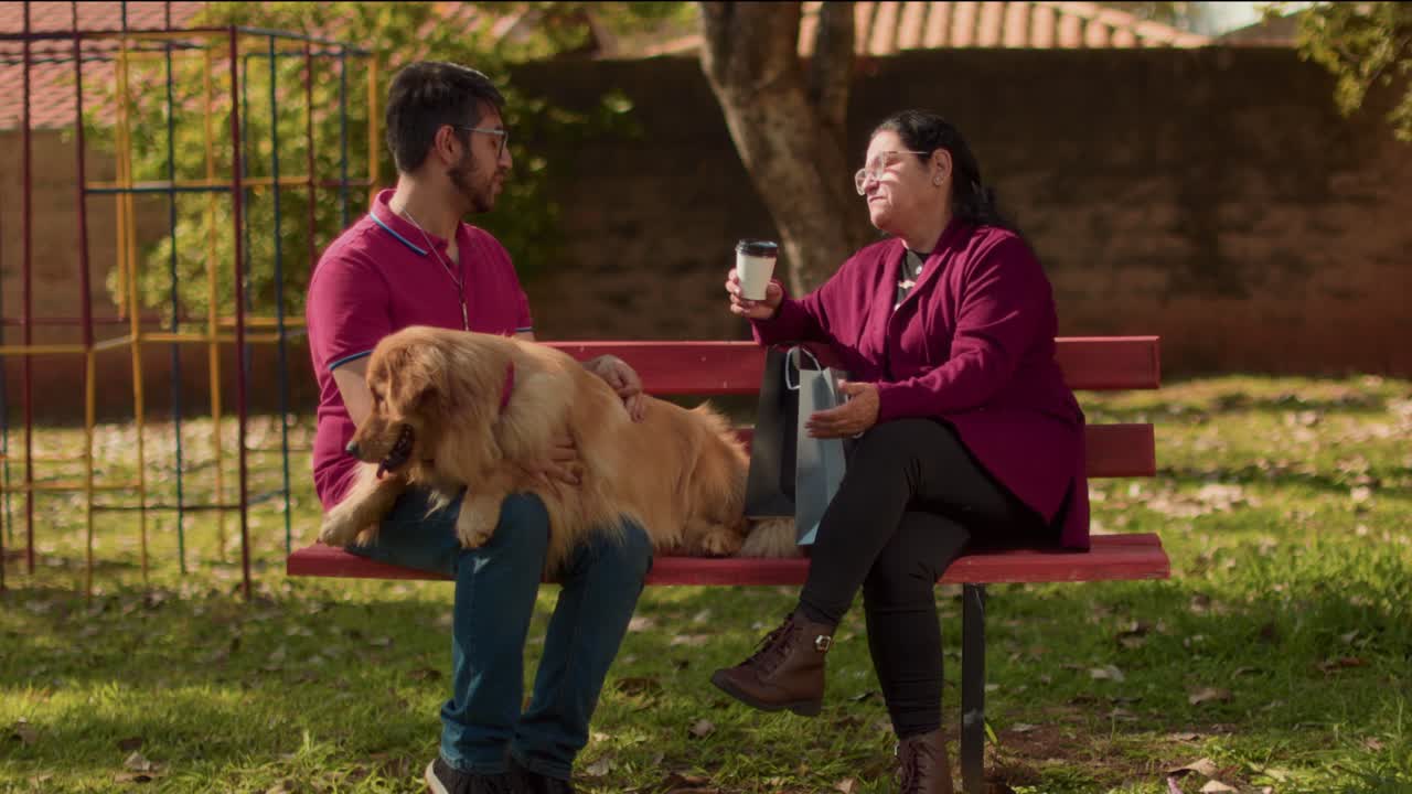People Conversing with Golden Retriever Dog on Park Bench
