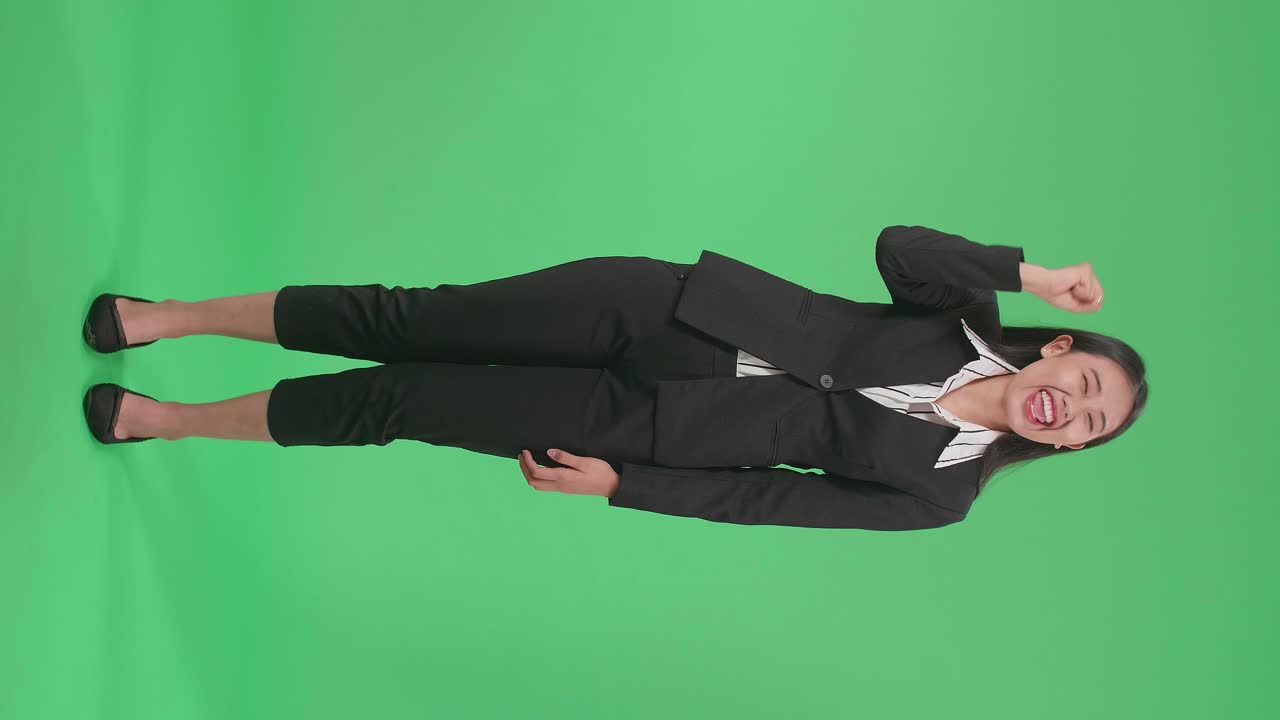 행복한 아시아 사업가 여성의 몸이 스튜디오에서 녹색 스크린에 서서 축하