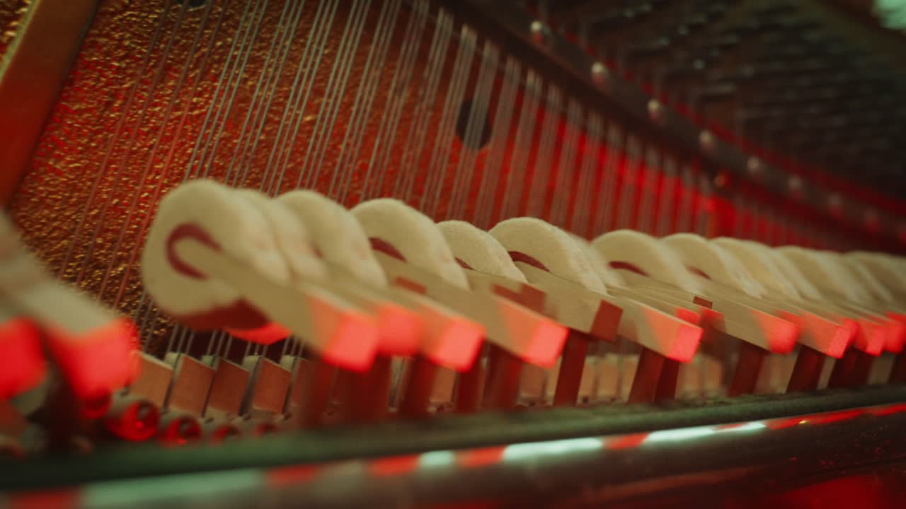 Detailed Macro of Piano Hammers and Strings Moving During Performance