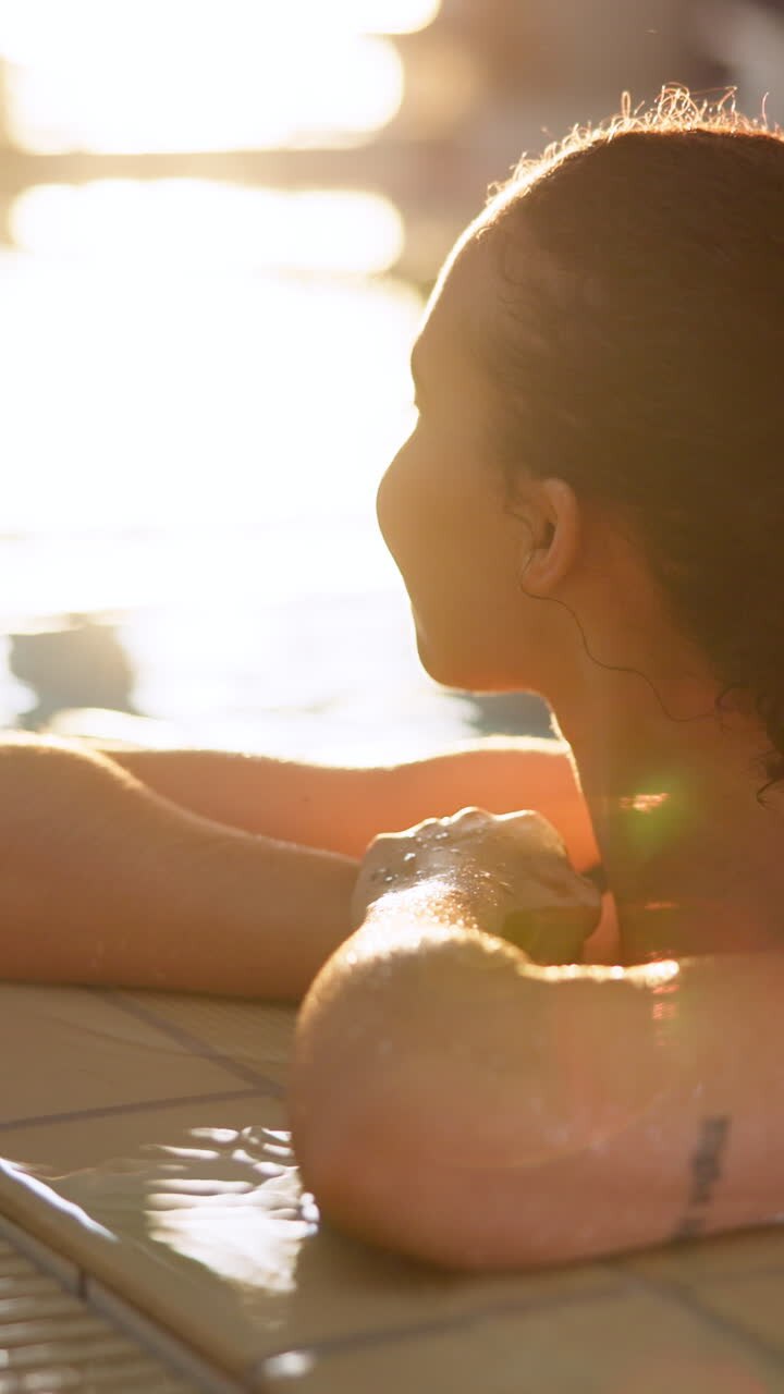 Woman relaxing by the pool on a sunny day