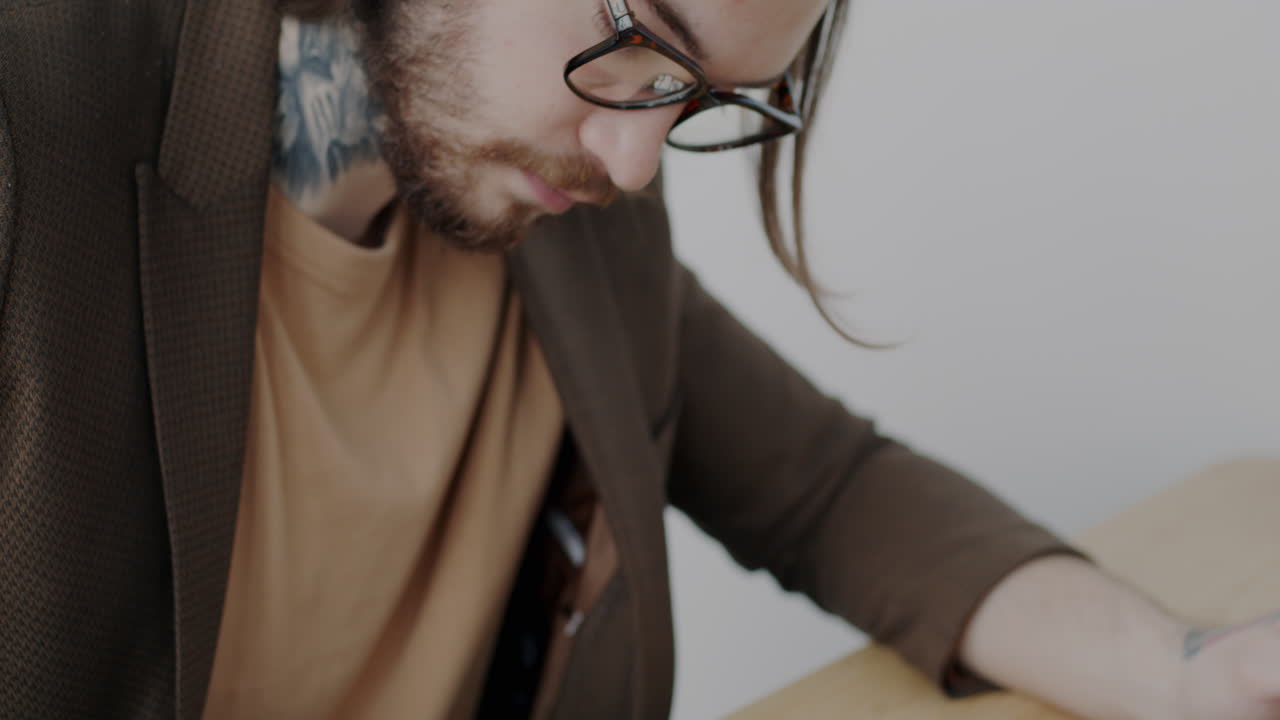 Man working on laptop and writing notes