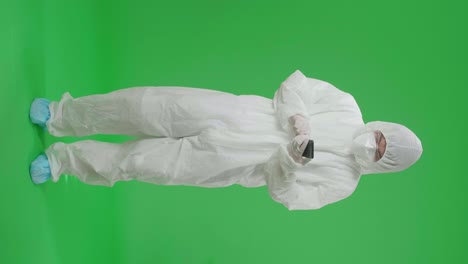 Person in Protective Suit Using a Phone