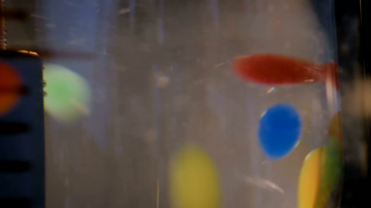 Moving colorful pills, tablets, drugs, meds in water at pharma exhibition