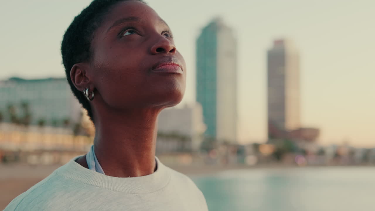 Thoughtful Young African American Woman Gazing at the Urban Beach