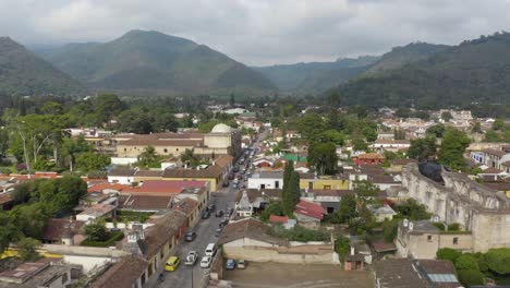 rising over the cityscape of antigua, sunny day in guatemala - aerial view