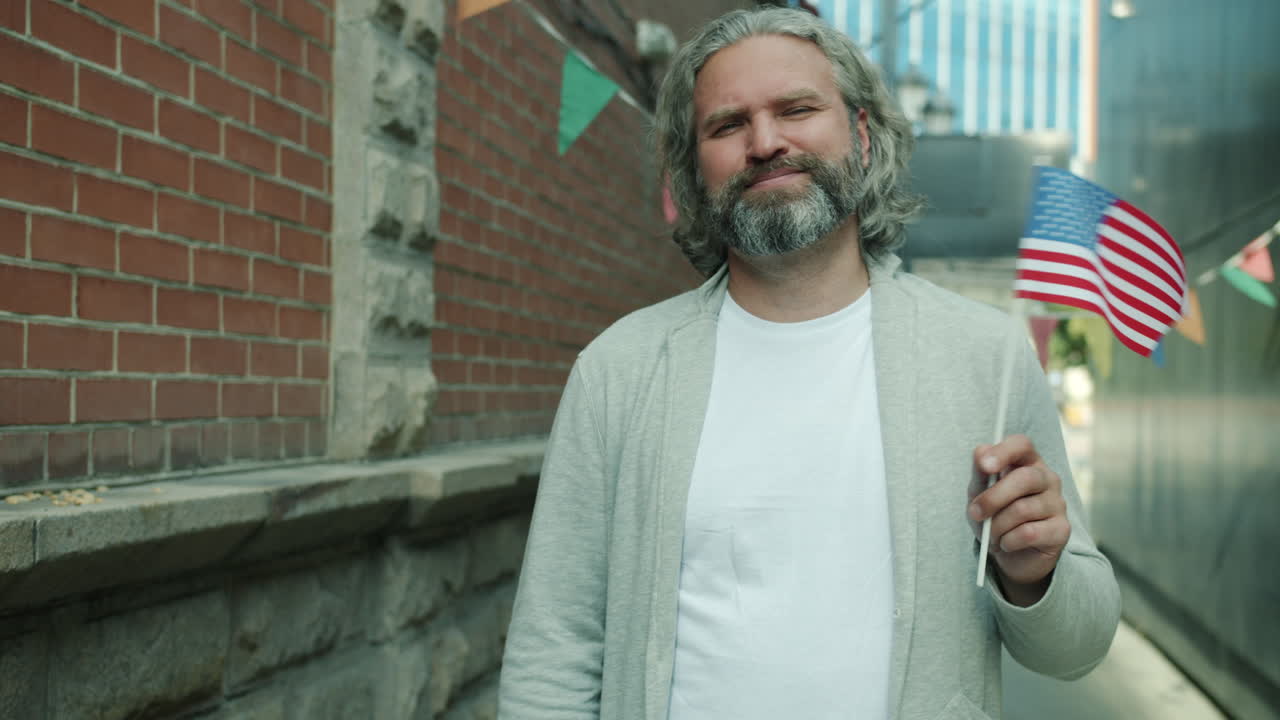 Man Holding American Flag in Urban Setting