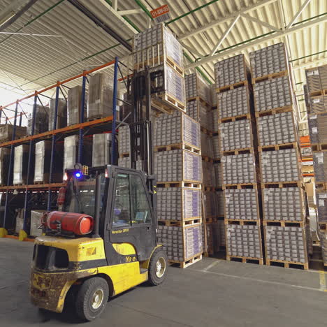 forklift among the materials in the hangar. floor and parquet storage.