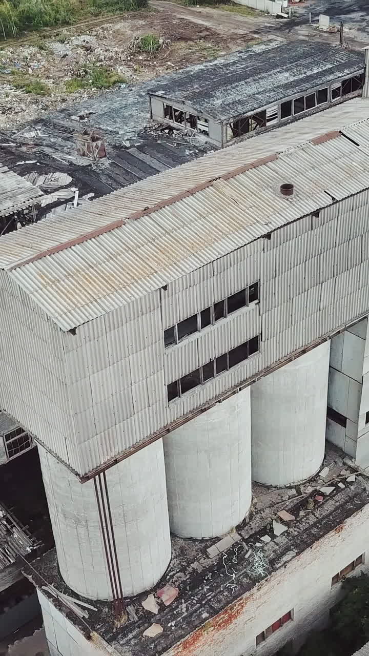 Abandoned industrial building. Ruins of an old factory. Aerial view. Vertical video