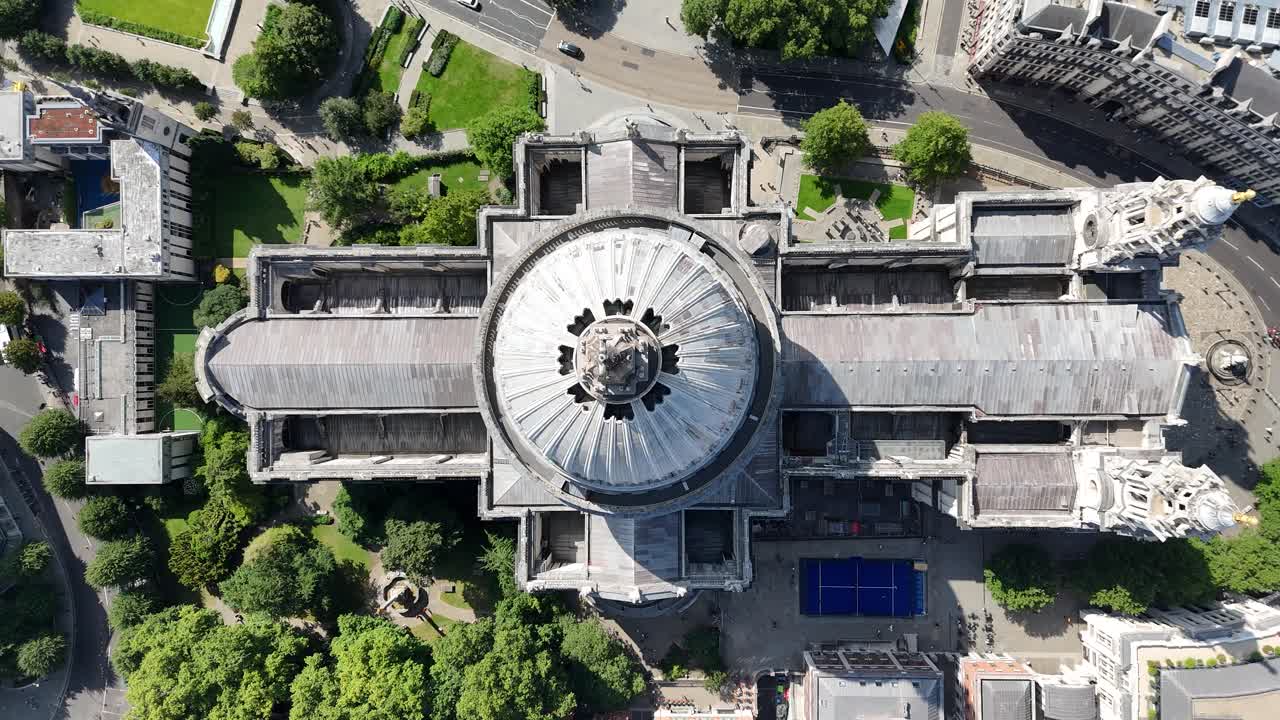 Breathtaking bird’s eye aerial view of St. Paul’s Cathedral, showcasing its grand dome, intricate architecture, and surrounding historic London streets bathed in soft daylight