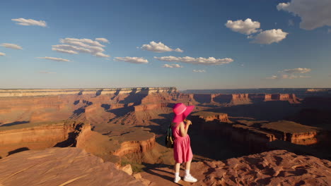 young girl in pink hat at grand canyon overlook
