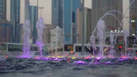 purple water fountain show in a city