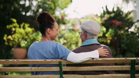 caregiver and senior on park bench