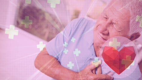 animación del corazón y cruza iconos sobre el anciano hombre caucásico en el dolor sosteniendo su pecho
